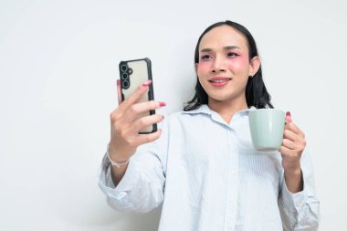 Makyajlı ve uzun saçlı Taylandlı genç bir transseksüelin stüdyo portresi. Cinsiyet ifadesi kavramı, LGBTQ gururu ve özgün güzellik ve çeşitliliği gösteren kapsayıcılık.