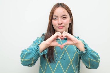 Studio portrait of a young Asian woman against white background