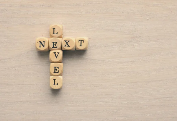 Words Next Level Small Wooden Blocks Wooden Table Space Text — Stock Photo, Image