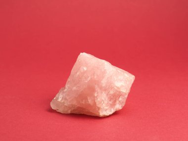 Kırmızı zemin üzerinde gül kuvars sert taş, mineraller veya şifalı taşlar