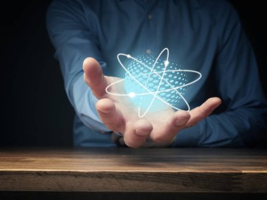 Her şey enerjidir, iş adamı elinde enerjik bir top tutar, atomlar tarafından sembolize edilen pozitif enerji, pozitif düşünce, yaratıcılık, minset konsept