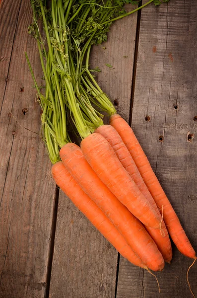 Organic carrots on wood
