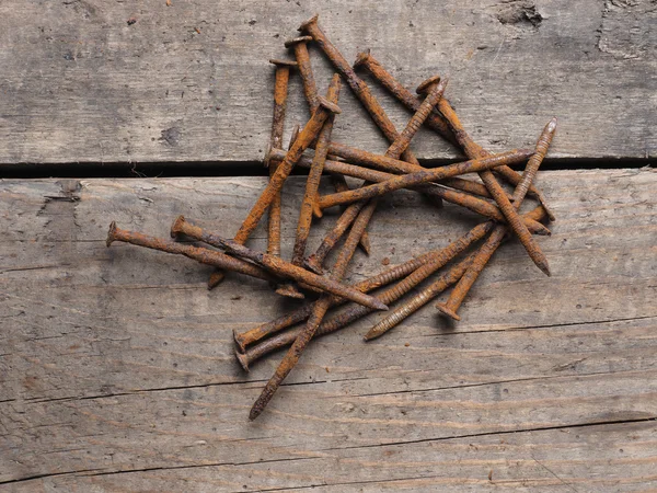 Rusty nails on wood — Stock Photo, Image