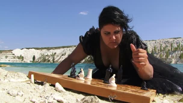 Portrait of Young Woman In Black Dress With Board Of Chess Near Lake — Stock Video