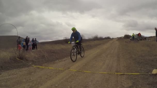 EDITORIAL. ciclistas de bicicleta cruzando linha de chegada no campo — Vídeo de Stock