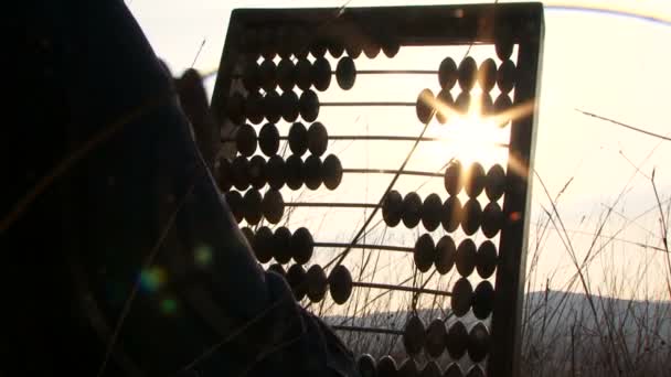 Woman In Black Moving Beads On Abacus At Nature — Stockvideo