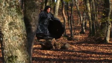 Woman In Black Running In Autumn Forest