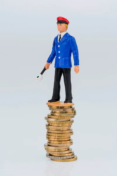 Railway worker stands on money stack — Stock Photo, Image