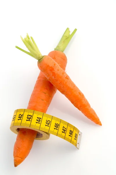 Fresh carrots with tape measure — Stock Photo, Image