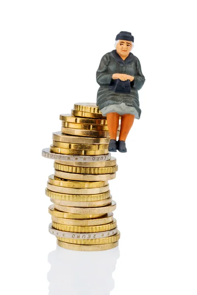 Pensioner sitting on a pile of money — Stock Photo, Image