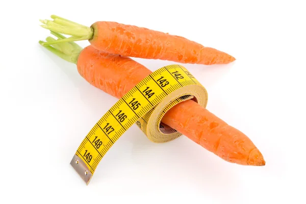 Fresh carrots with tape measure — Stock Photo, Image