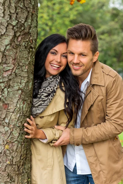 Courting couple behind a tree — Stock Photo, Image