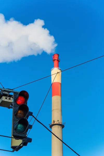 Industrial chimney and red traffic lights — Stock Photo, Image