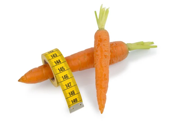 Fresh carrots with tape measure — Stock Photo, Image