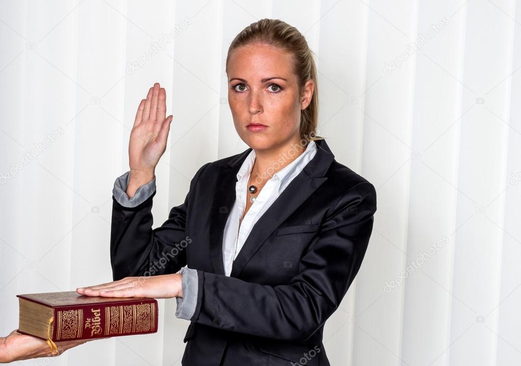 Woman Swears On The Bible Stock Photo Ginasanders 58649063 woman-swears-on-the-bible-stock-photo-ginasanders-58649063