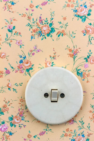 Old wallpaper with light switch — Stock Photo, Image