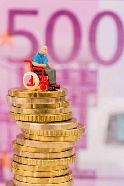 Woman in wheelchair on money stack — Stock Photo, Image