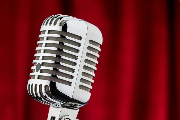 Retro microphone against red velvet — Stock Photo, Image