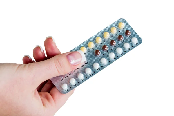 Mão tomando pílulas anticoncepcionais — Fotografia de Stock