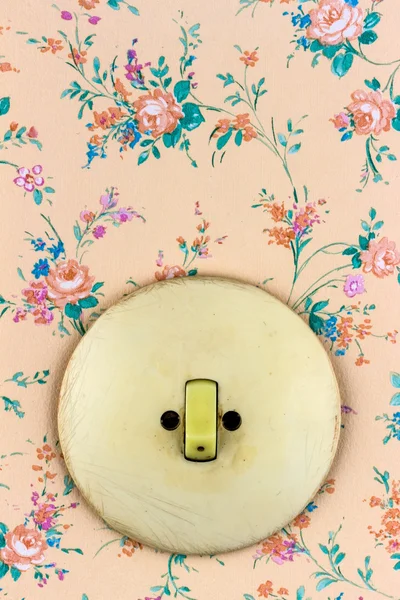 Old wallpaper with light switch — Stock Photo, Image