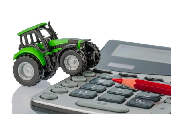 Tractor, pluma roja y calculadora — Foto de Stock
