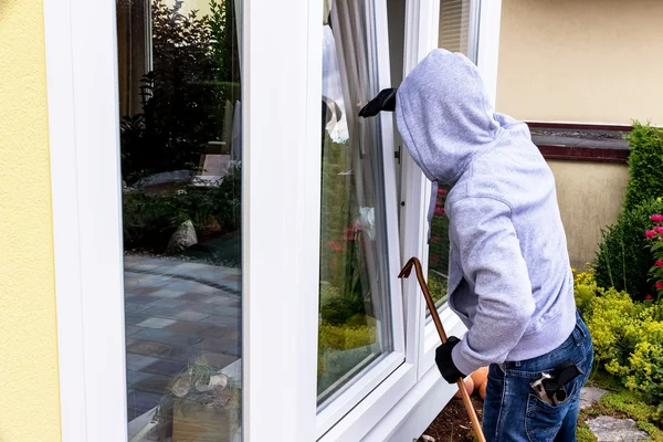 Burglar at a window — Stock Photo, Image