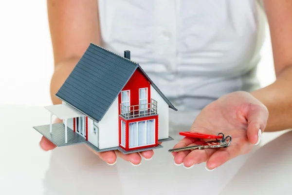 Real estate agent with house and key — Stock Photo, Image