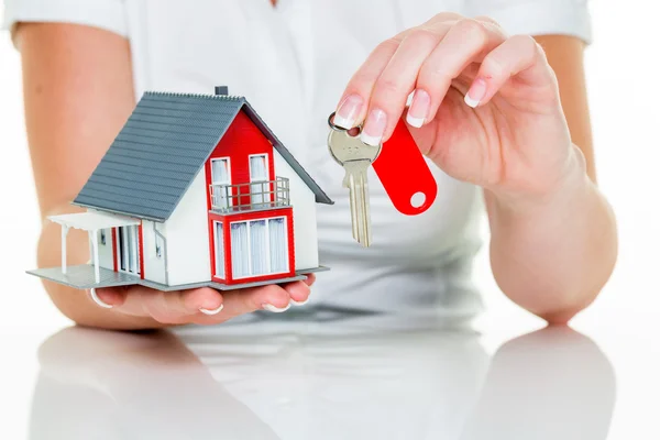 Real estate agent with house and key — Stock Photo, Image