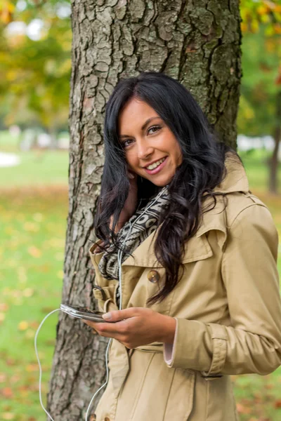 Kvinna lyssna på musik på mobiltelefon — Stockfoto