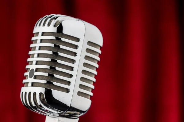 Retro microphone against red velvet — Stock Photo, Image