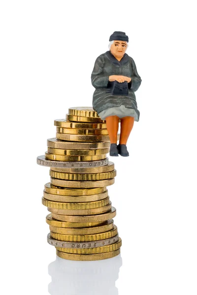 Pensioner sitting on a pile of money — Stock Photo, Image