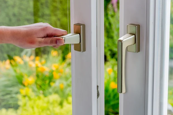 Woman opens window for ventilation — Stock Photo, Image