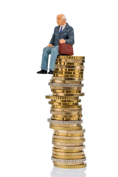 Pensioners sitting on cash pile — Stock Photo, Image