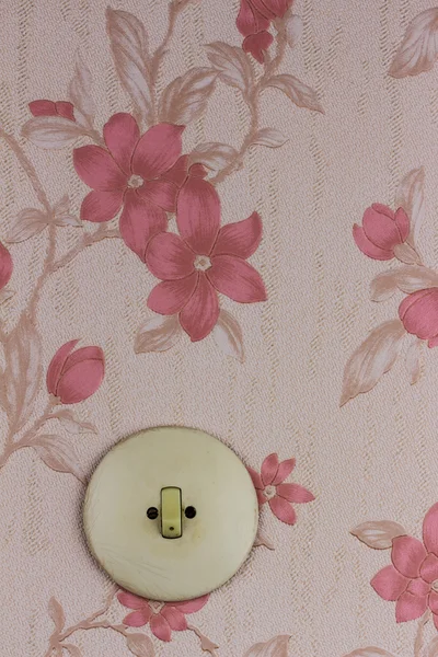 Old wallpaper with light switch — Stock Photo, Image