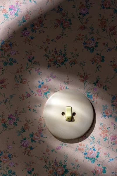 Old wallpaper with light switch — Stock Photo, Image