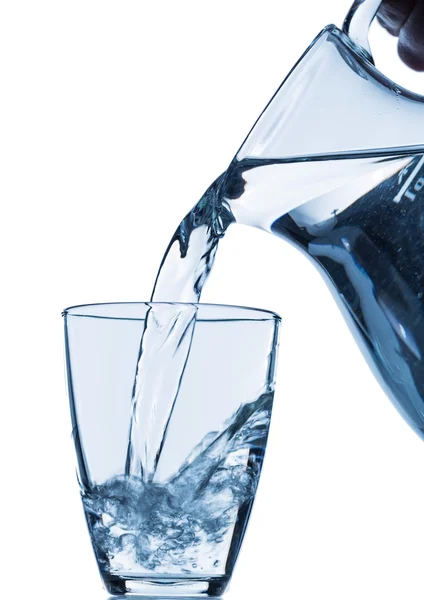 Glass with water and jug — Stock Photo, Image