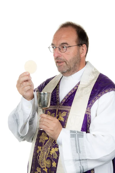 Catholic priest with chalice and host at kom — Stock Photo, Image