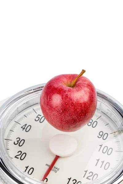 Apple lying on a balance — Stock Photo, Image