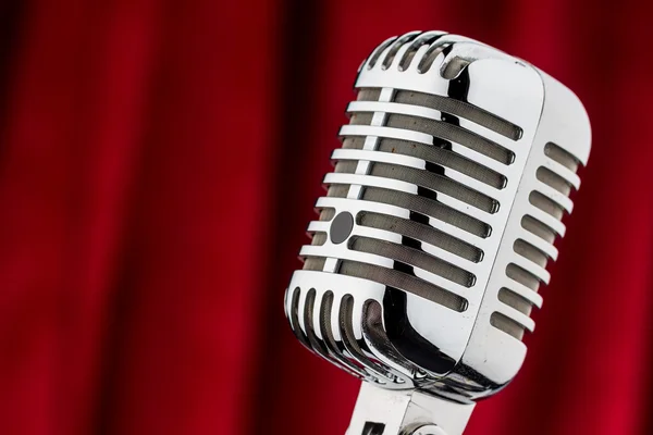 Retro microphone against red velvet — Stock Photo, Image