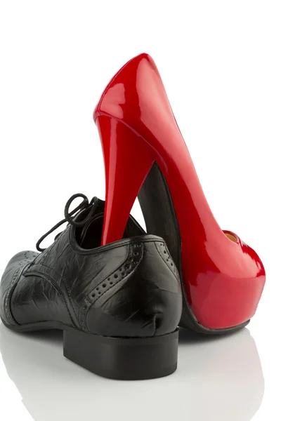 Red high heels and mens shoe — Stock Photo, Image