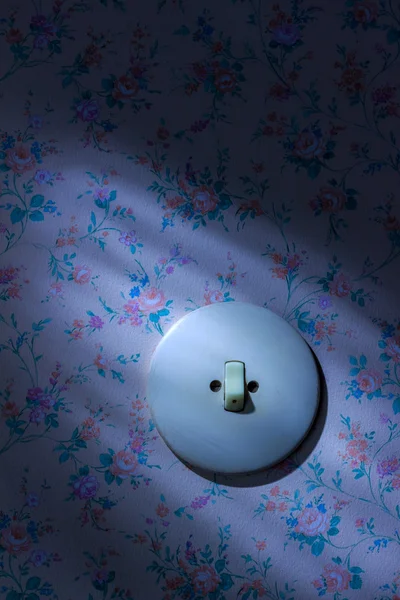 Old wallpaper with light switch — Stock Photo, Image