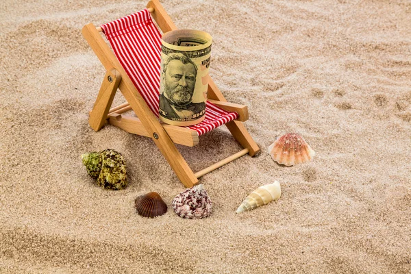 Deck chair with piggy bank and dollars — Stock Photo, Image