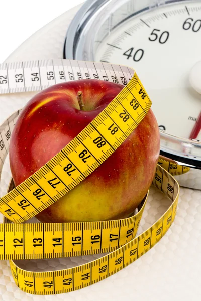 Apple lying on a balance — Stock Photo, Image