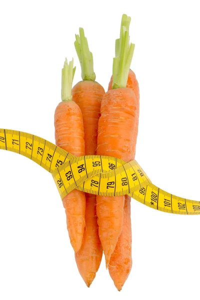 Fresh carrots with tape measure — Stock Photo, Image