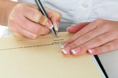 hand with fountain pen signing contract clipart