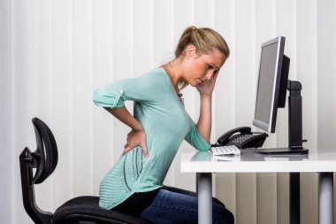 woman with back pain in the office clipart
