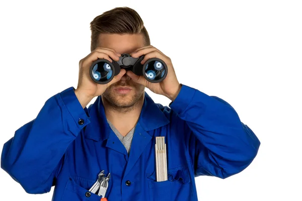 Craftsman with binoculars — Stock Photo, Image