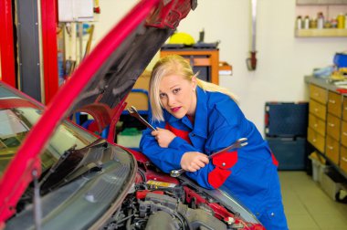 woman as a mechanic in auto repair shop clipart