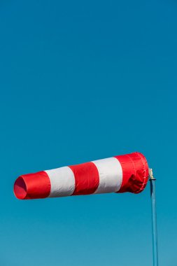 windsock against a blue sky clipart