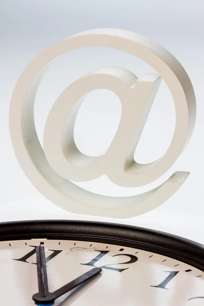 Email sign and clock — Stock Photo, Image